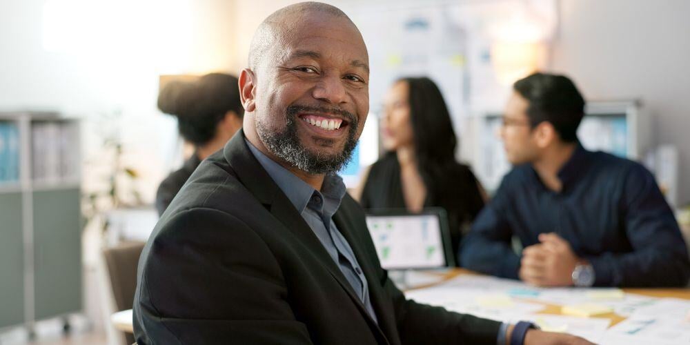 A confident professional in a business meeting, exemplifying leadership on how to become a cybersecurity champion for your organization.