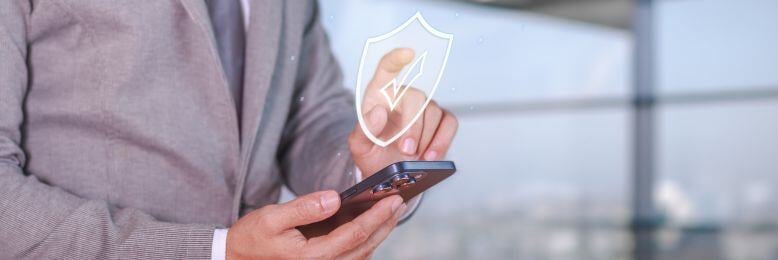 Businessman using a secure Bluetooth connection on a smartphone to enhance cybersecurity protection