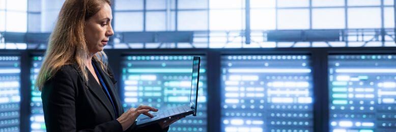 Businesswoman examining IT outsourcing solutions and costs in a server room for the public sector