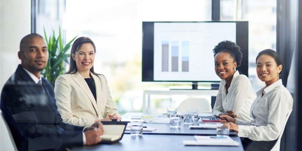 Corporate team analyzing data and discussing challenges of FINRA compliance in a boardroom meeting