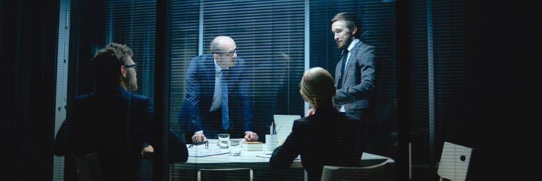 Executives in a meeting room discussing the MSP vetting process