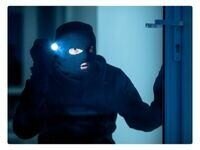 a burglar holding a flashlight